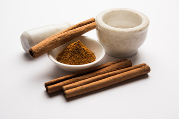 Powder cinnamon and sticks also known as Dalchini or Dalcheenee masala from India, selective focus