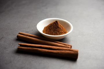 Powder cinnamon and sticks also known as Dalchini or Dalcheenee masala from India, selective focus