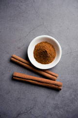 Powder cinnamon and sticks also known as Dalchini or Dalcheenee masala from India, selective focus