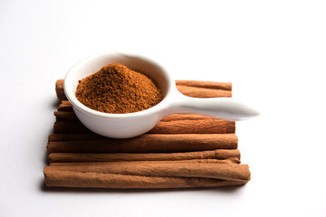 Powder cinnamon and sticks also known as Dalchini or Dalcheenee masala from India, selective focus