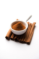 Powder cinnamon and sticks also known as Dalchini or Dalcheenee masala from India, selective focus