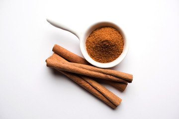 Powder cinnamon and sticks also known as Dalchini or Dalcheenee masala from India, selective focus