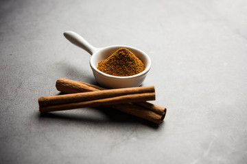 Powder cinnamon and sticks also known as Dalchini or Dalcheenee masala from India, selective focus