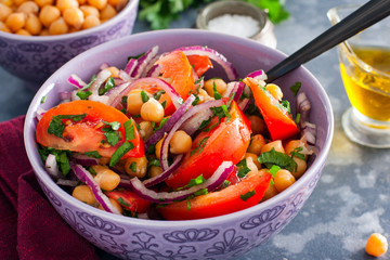 Salad with tomatoes, chickpeas and red onions, selective focus