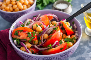 Salad with tomatoes, chickpeas and red onions, selective focus