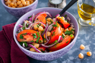 Salad with tomatoes, chickpeas and red onions, selective focus