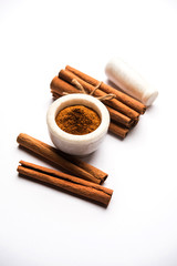 Powder cinnamon and sticks also known as Dalchini or Dalcheenee masala from India, selective focus
