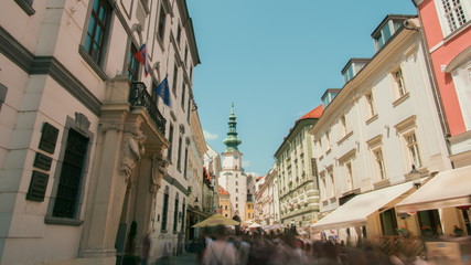 Fototapeta na wymiar Landmark Capital of Slovakia - Bratislava, Tourists People Walking and Sightseeing in Old Town, Michalska Street with Medieval Michael's Gate (Brana)