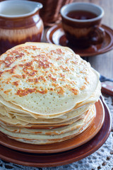 Homemade thick pancakes stacked on a plate, selective focus
