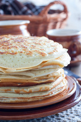 Homemade thick pancakes stacked on a plate, selective focus