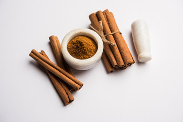 Powder cinnamon and sticks also known as Dalchini or Dalcheenee masala from India, selective focus