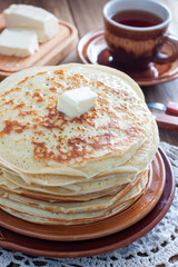 Homemade thick pancakes stacked on a plate, selective focus