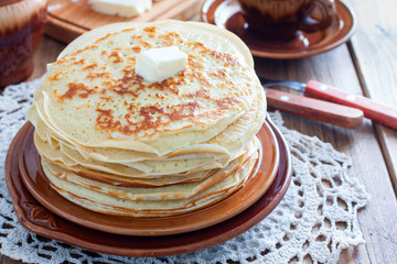 Homemade thick pancakes stacked on a plate, horizontal, copy space