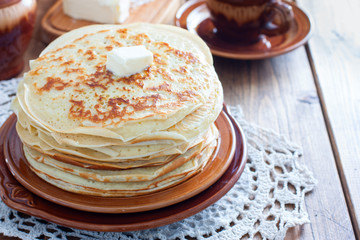 Homemade thick pancakes stacked on a plate, horizontal, copy space
