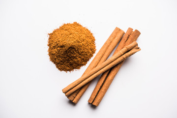 Powder cinnamon and sticks also known as Dalchini or Dalcheenee masala from India, selective focus