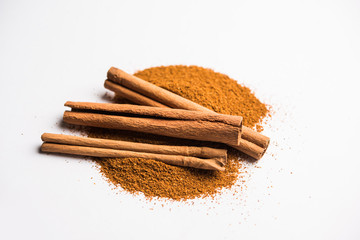 Powder cinnamon and sticks also known as Dalchini or Dalcheenee masala from India, selective focus