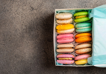 Mixed of Colorful Macarons cake on grey background with copy space. Sweet and colorful french macaroons on grey background.