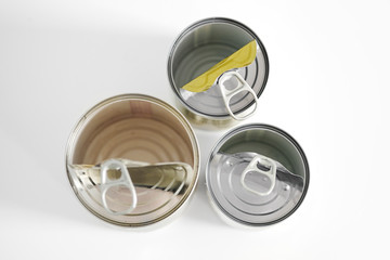 Three empty tin cans on a gray background top view.Concept of Recycling, ecology and minimalism. Plastic waste. Stop nature garbage, ecology environment protection concept. 