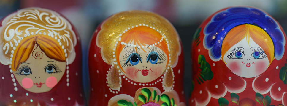 There is a large range of bright colorful Matreshka-dolls (traditional Russian wooden nesting toys) in the store. Red, yellow, green, blue colors.