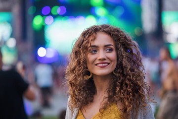 Portrait of young woman standing at summer festival.