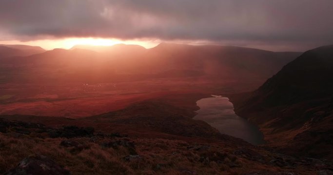 Breathatking and spectacular 4K Time lapse video of sunrise in Brandon mountains, with moving slouds, shadows and sun rays, Dingle Peninsula, Ireland