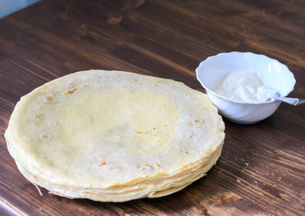 pancakes on a plate with sour cream