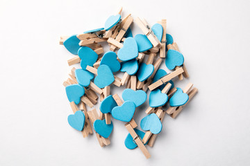 Wooden clips with Blue hearts. White background