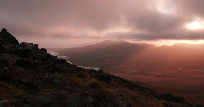 Breathatking and spectacular 4K Time lapse video of sunrise in Brandon mountains, with moving slouds, shadows and sun rays, Dingle Peninsula, Ireland
