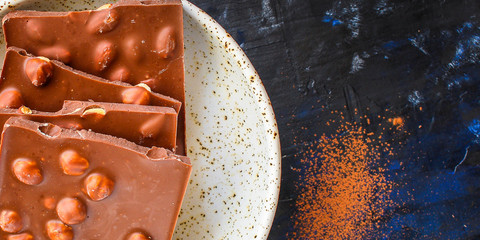 chocolate bar hazelnuts and almonds (delicious sweet dessert snack) menu concept. background. top view. copy space for text