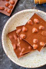chocolate bar hazelnuts and almonds (delicious sweet dessert snack) menu concept. background. top view. copy space for text