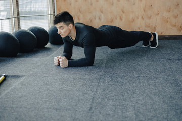 sports guy doing plank exercise. gym and sports. healthy lifestyle.