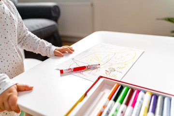 Baby toddler at daycare or home paining with felt tip pens.