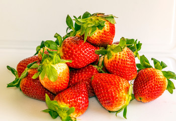 Several strawberries surrounded by white background