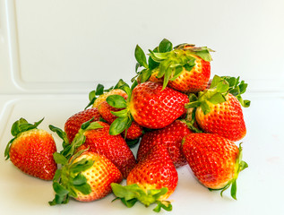 Several strawberries surrounded by white background
