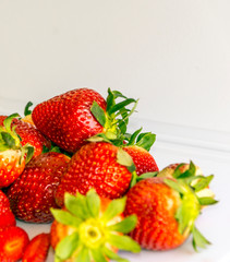 Several strawberries surrounded by white background