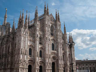 Fototapeta premium Duomo di Milano on background of blue sky at sunny day, Milan, Lombardy, Italy