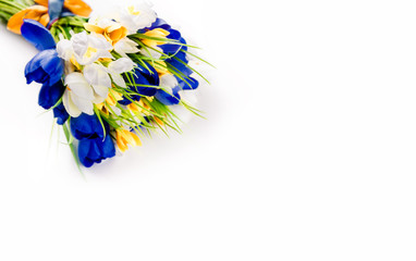 Artificial bouquet of white, yellow and blue flowers on a white background