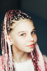 Very cute girl with braided Afro pigtails with a thread of pink color very beautiful
