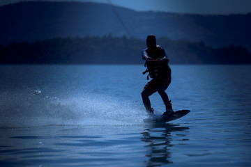 silhouette of a wakeboarding on moonlight