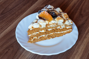 Honey lavender cake made with sponge cake infused with honey and filled with layers of lavender mousse, adorned with dried apricot and plum.