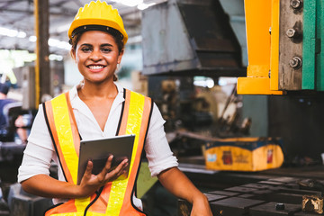 Industry maintenance engineer woman dark skin wearing uniform and safety helmet under inspection...