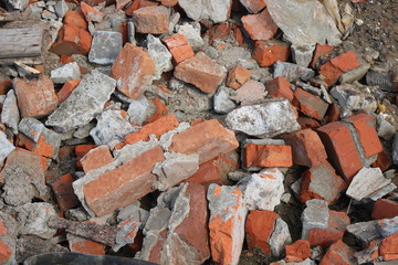 Construction waste with elements of and destroyed old structures at municipal landfill