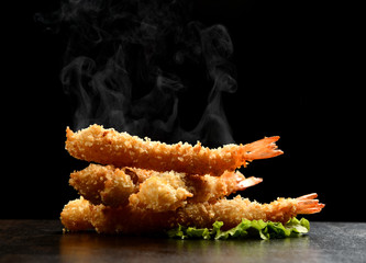 Fast sea food concept. Hot and spicy langoustines prawns in batter with steam smoke