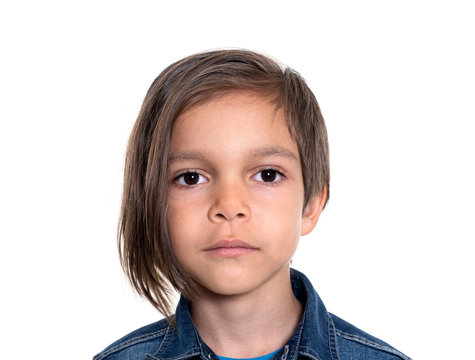 serious little boy on white background