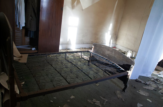 Old fashioned spring bed in abandoned farmhouse