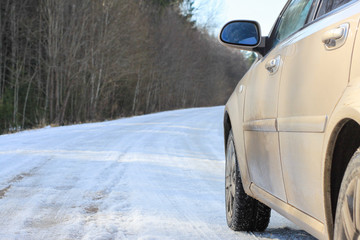 Fototapeta premium spring dirt road. beige car sedan.