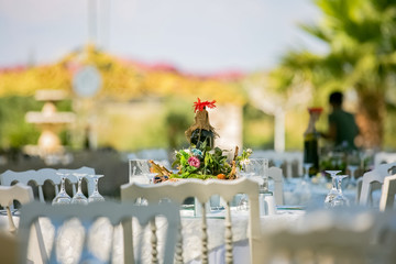 Wedding decoration, with branches of greenery, stands on the green lawn in the wedding area