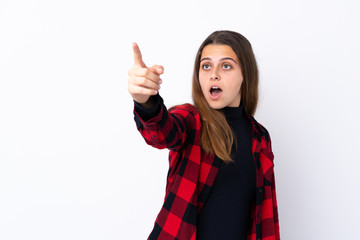 Teenager girl over isolated white background pointing away