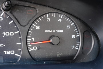 Fuel gauge, vehicle engine temperature, Miles Per Hour Speed indicator, and revolutions per minute indicator on a vehicle dashboard