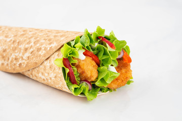 Wrap with fried chicken and vegetables isolated on a white background